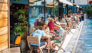 The Lido Restaurant people eating by the side of the pool