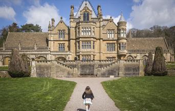 Girl playing in the garden at Easter at Tyntesfield, North Somerset by Rob Stothard