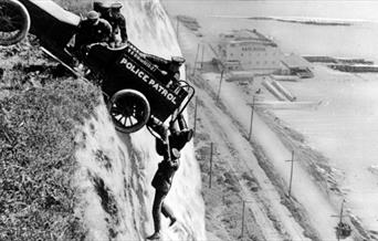 When Stunts go wrong - man holding onto a car, hanging off a cliff