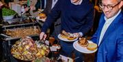 People enjoying a Christmas party buffet at Wake The Tiger