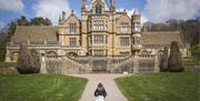 Girl playing in the garden at Easter at Tyntesfield, North Somerset by Rob Stothard