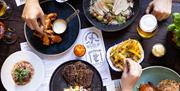 Plates of food on an indoor table at Green Park Brasserie