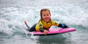 Child body boarding at The Wave